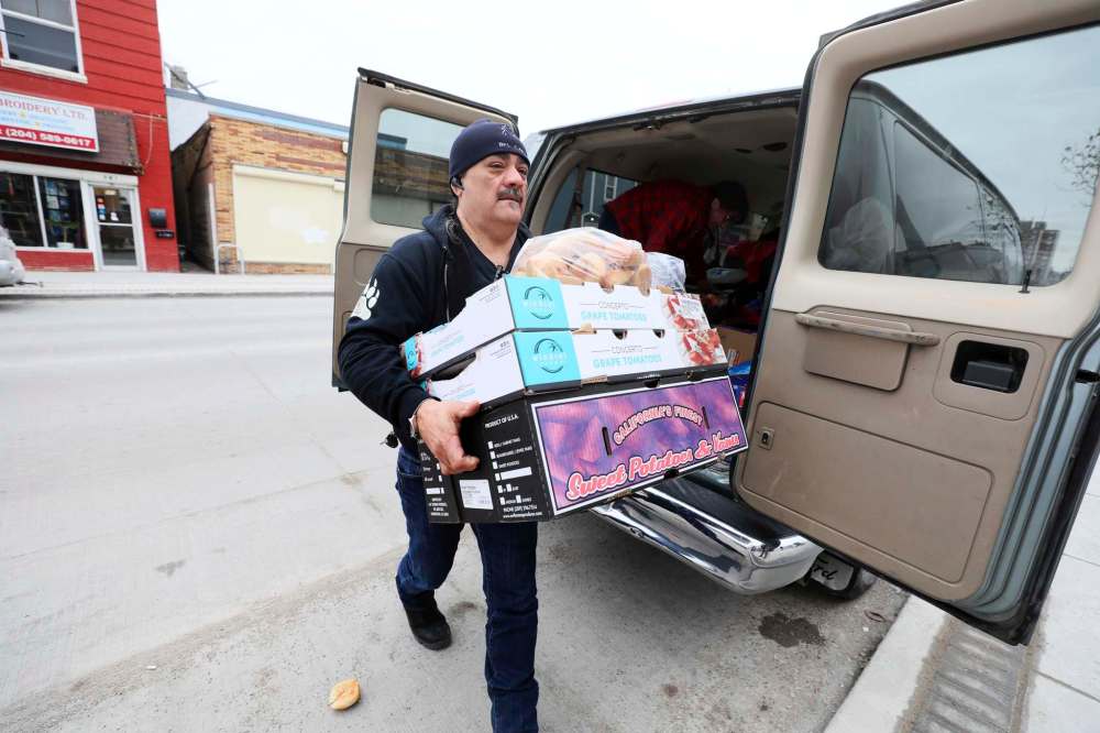 RUTH BONNEVILLE / WINNIPEG FREE PRESS
Favel carries a load of donated food items.