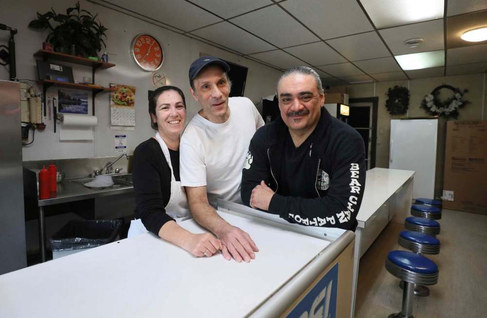 RUTH BONNEVILLE / WINNIPEG FREE PRESS
Susan (left) and Angelo Tiginagas with Favel at his favourite eatery, Angelo’s Chip Shop, on Main Street.