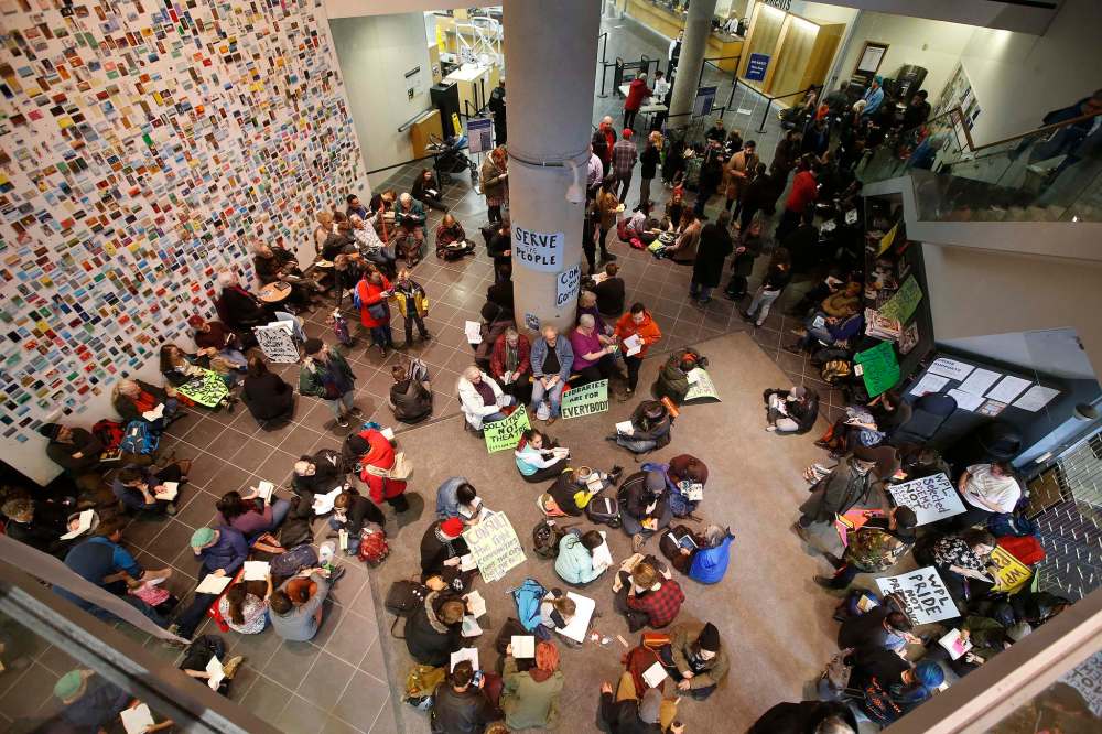 JOHN WOODS / WINNIPEG FREE PRESS
About two hundred protestors take part in a sit-in at Millennium Library in Winnipeg, Tuesday, to protest the use of security checks to enter the library.