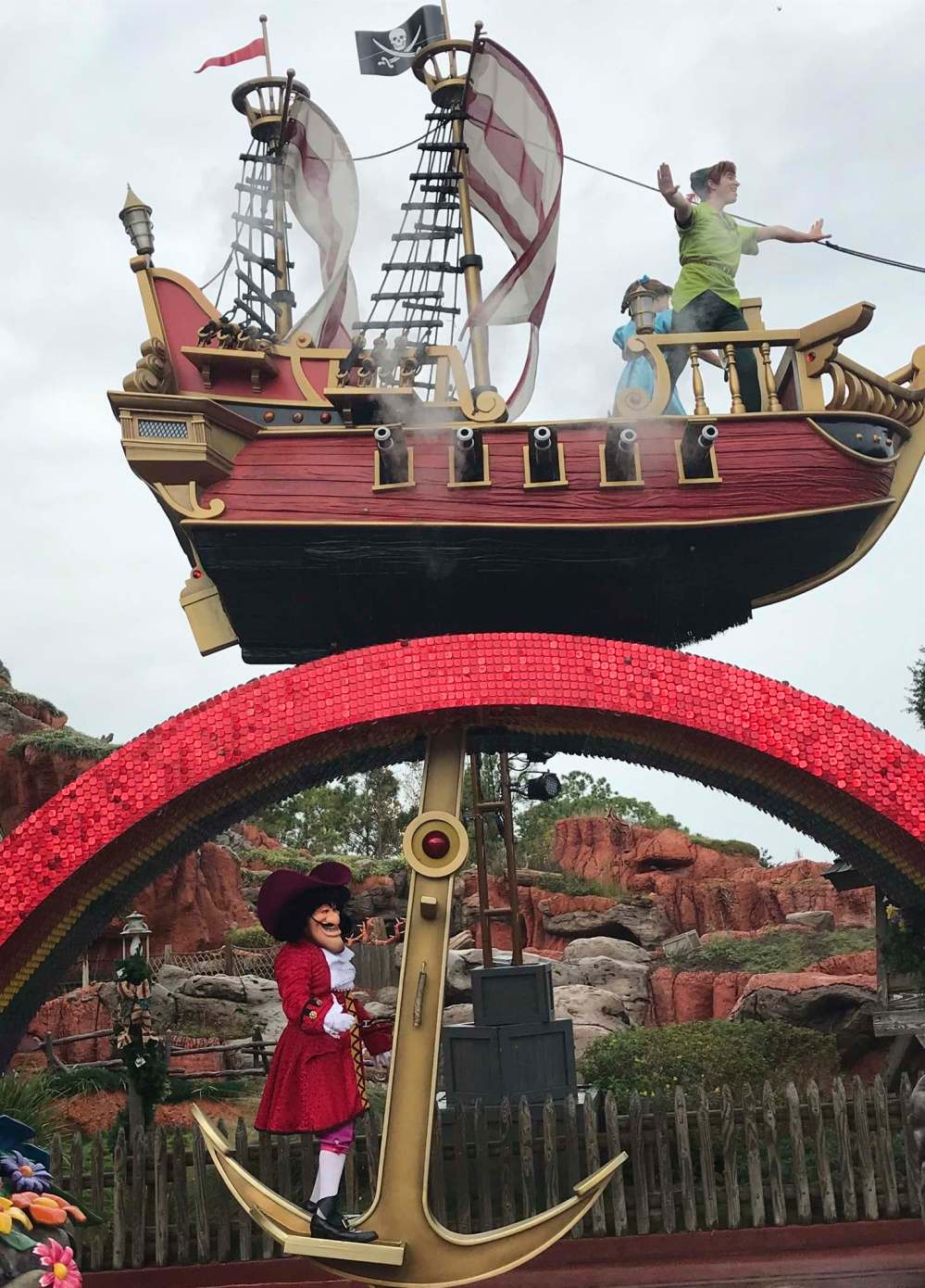 Parades featuring a cast of Disney characters delight visitors to Disney World. Here Peter Pan and Captain Cook perform atop their float near Splash Mountain.
