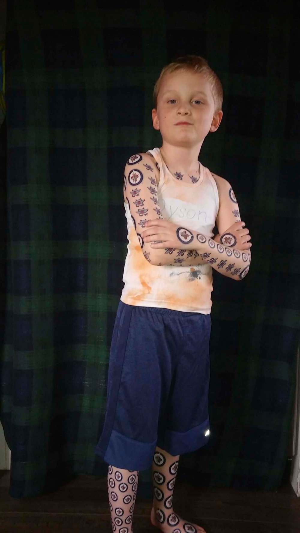 Dyson Labossiere, 7, used 436 temporary tattoos featuring his favourite team, the Winnipeg Jets, to set a new record. (SUPPLIED)