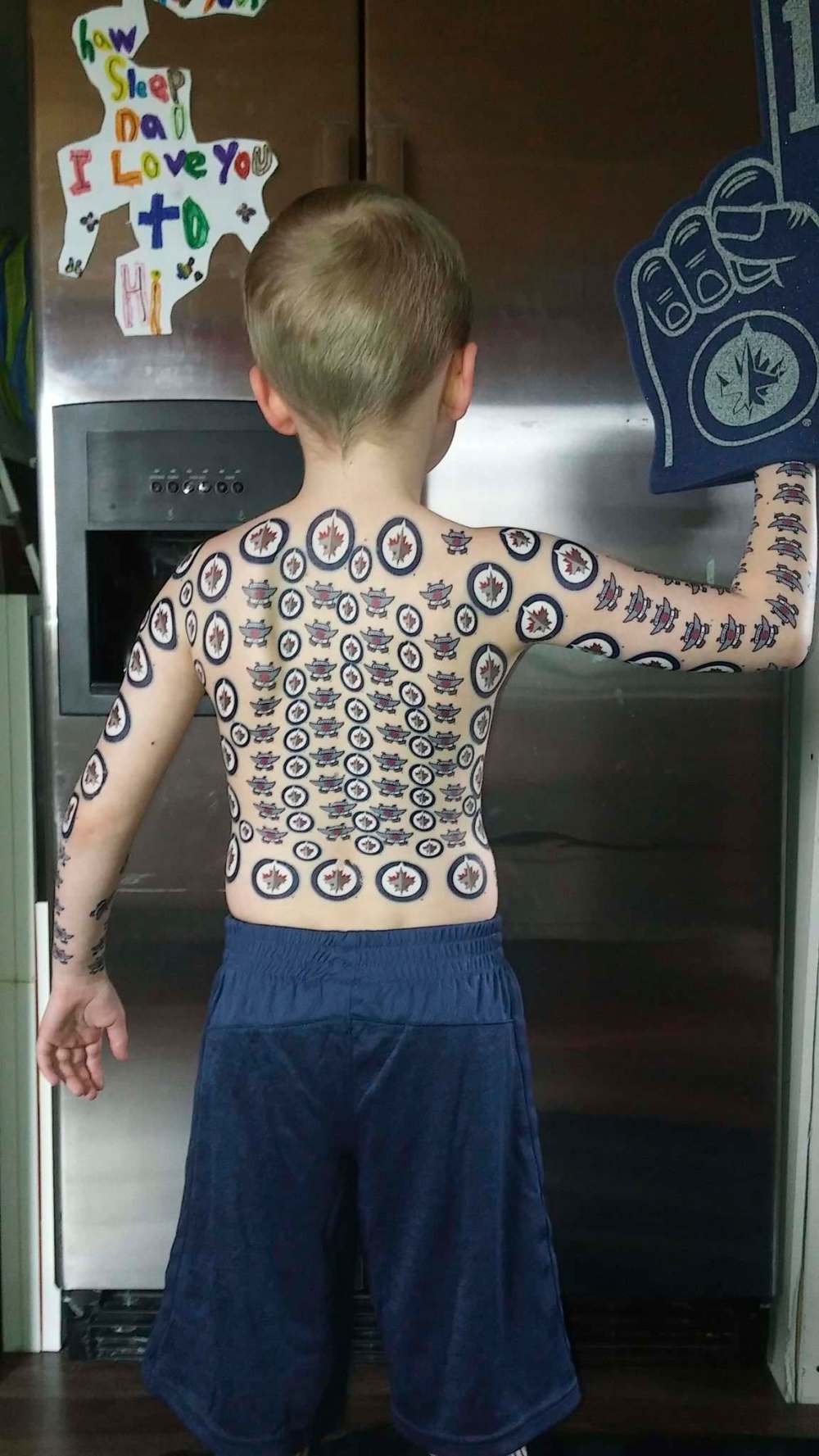 With $70 worth of temporary tattoos featuring his beloved NHL team, and help from his dad, Dylon Labossiere set out to break the record for having the most wash-away tats at once. (SUPPLIED)