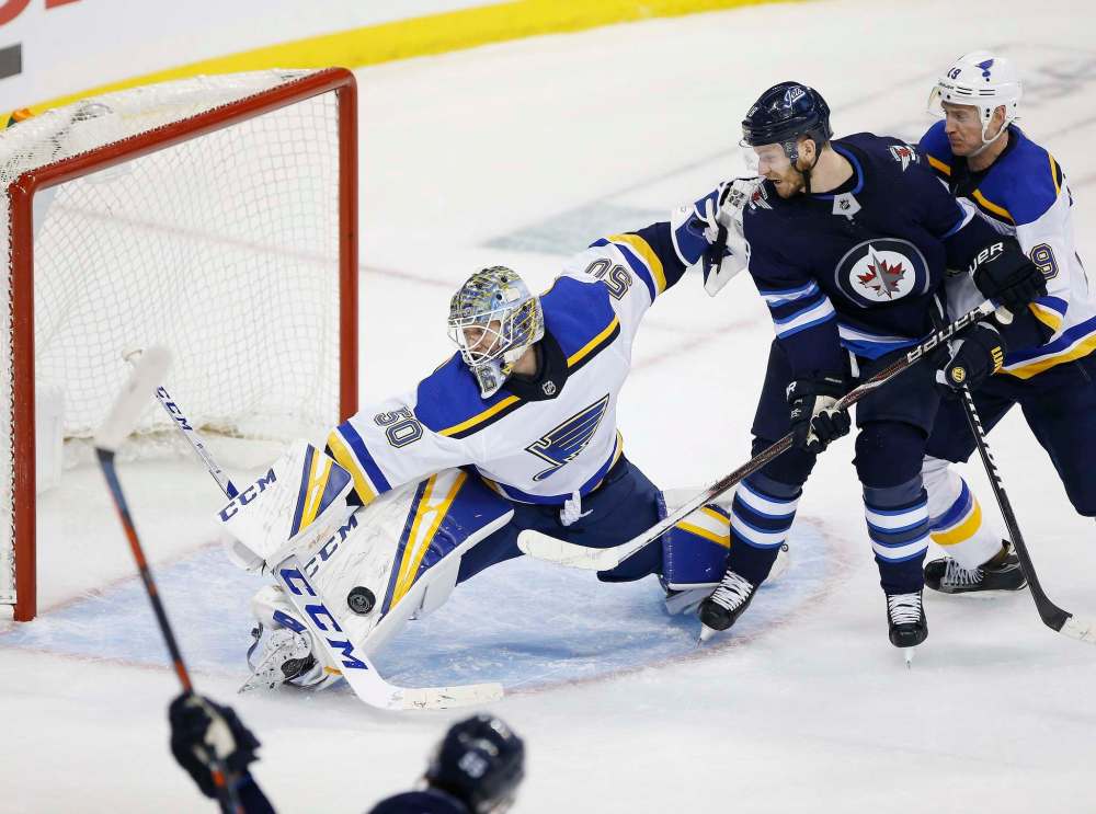 Jordan Binnington stops Mark Scheifele's shot in the final minute that would have sent the game into overtime if it went in. (John Woods / The Canadian Press)