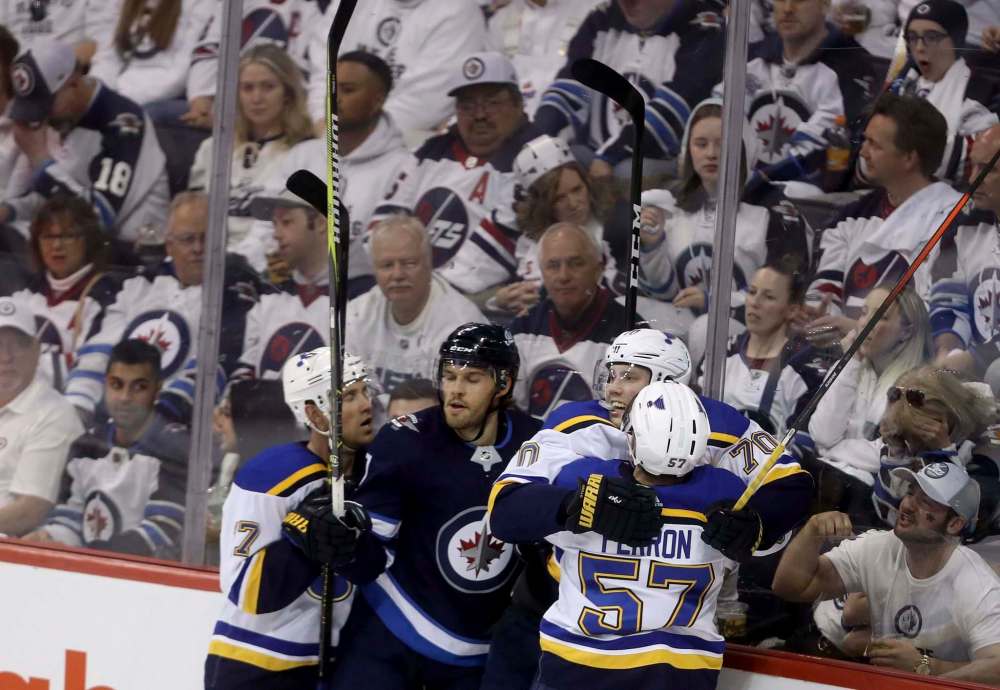 Jets d-man Ben Chiarot finds himself in the middle of a Blues goal celebration in Game 2. (Trevor Hagan / Winnipeg Free Press)