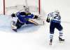 Jeff Roberson / The Associated Press files
Patrik Laine puts the puck past Blues goaltender Jordan Binnington on Sunday.