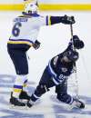 Winnipeg Jets' Mathieu Perreault (85) gets checked by St. Louis Blues' Joel Edmundson (6) during third period NHL playoff action in Winnipeg on Wednesday, April 10. (John Woods / The Canadian Press files)