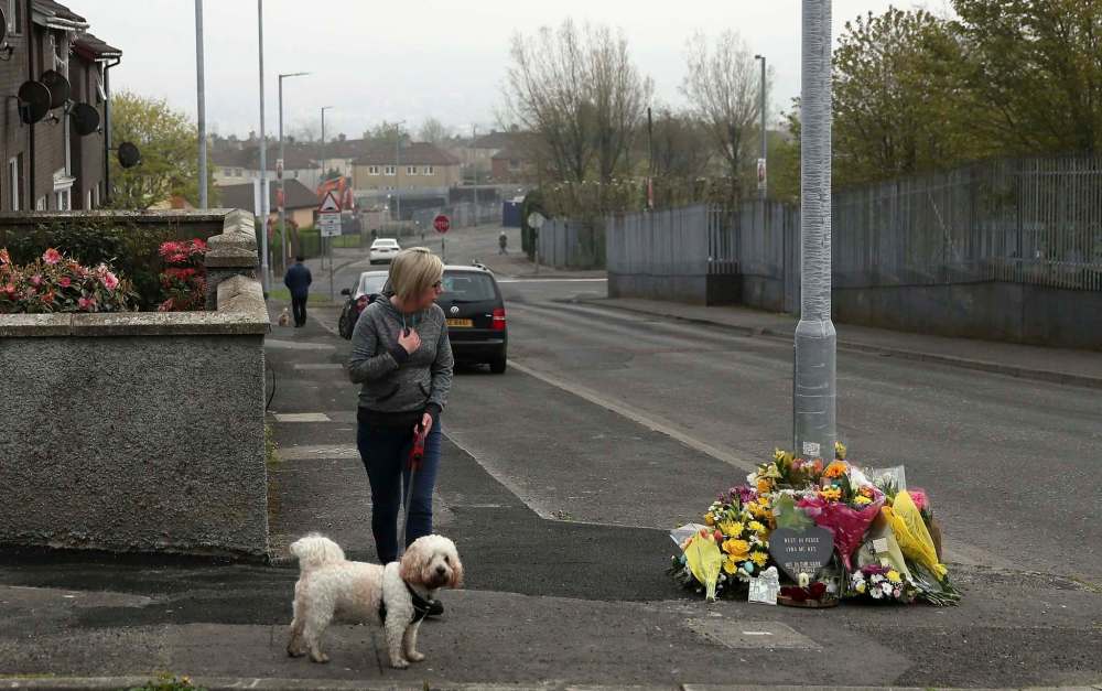 Brian Lawless / PA / The Associated Press Files
A woman stops to pay her respects at the scene where 29-year old journalist Lyra McKee was fatally shot while covering riots in Londonderry, Northern Ireland, on April 18.