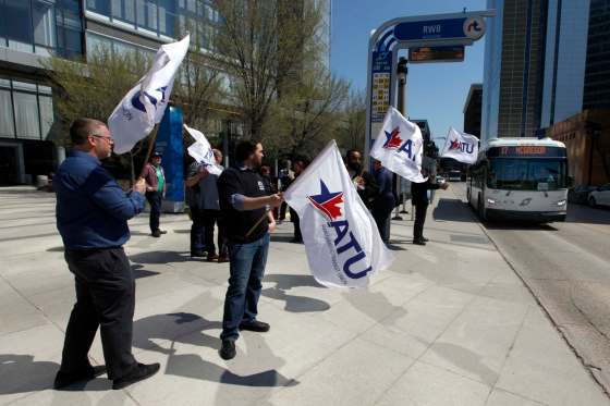 PHIL HOSSACK / WINNIPEG FREE PRESSAmalgamated Transit Union members wave flags at Edmonton Street and Graham Avenue on Monday.