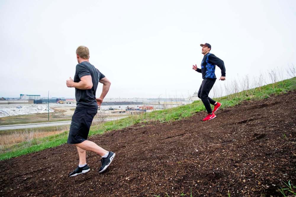Burr (left) and Garbutt (right) run backwards up the steep incline.