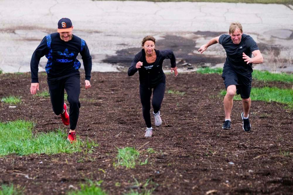 PHOTOS BY DANIEL CRUMP / WINNIPEG FREE PRESS
From left: Hockey player Ryan Garbutt, cyclocross athlete Cheryl Conklin and fitness coach Richard Burr race up the steep incline at Garbage Hill.
