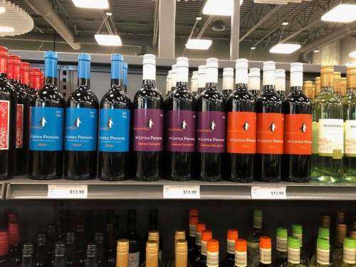 Despite being made in Australia, the Little Penguin Merlot (left) is shelved in the U.S. section with the American-made Cabernet Sauvignon (centre) and Shiraz. (Photos by Ben MacPhee-Sigurdson / Winnipeg Free Press)