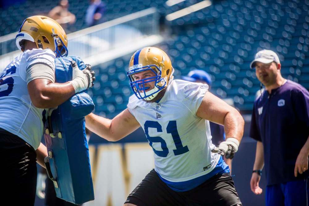 MIKAELA MACKENZIE / WINNIPEG FREE PRESS
Rookie offensive lineman Drew Desjarlais throws his weight around at camp Wednesday.