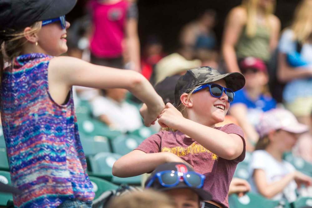 MIKAELA MACKENZIE / WINNIPEG FREE PRESS
Madelyn Eidse (left) and Bryn Labergne dance in the stands as the Goldeyes play against the Gary SouthShore RailCats at Shaw Park.