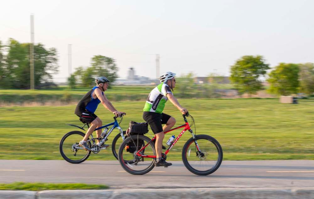 Cyclists ride the Yellow Ribbon Trail.