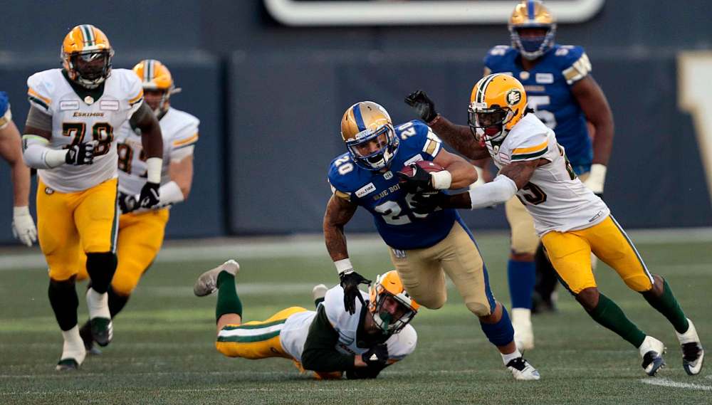 PHIL HOSSACK / WINNIPEG FREE PRESS
Winnipeg Blue Bombers running back Brady Oliveira dodges a tackle from Edmonton Eskimos' Scott Hutter in Pre-Season action at IG Field Friday.