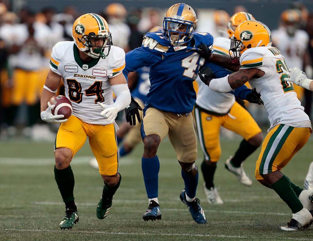 PHIL HOSSACK / WINNIPEG FREE PRESS
Edmonton Eskimos' Josh Stangby scampers away from Blue Bombers' Abu Conteh in Pre-Season action at IG Field Friday.