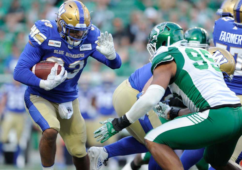 Mark Taylor/ The Canadian Press
Winnipeg Blue Bombers running back Andrew Harris picks up yards during first half CFL pre-season action at Mosaic Stadium in Regina on Thursday.