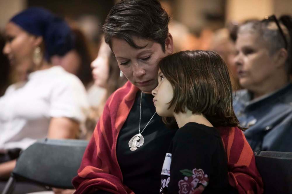 Darryl Dyck / The Canadian Press
British Columbia Minister of Advanced Education and Skills Training Melanie Mark and her daughter Makayla, 8, listen as Indigenous women and allies respond to the report on the National Inquiry into Missing and Murdered Indigenous Women and Girls, in Vancouver, on June 3.