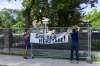 SASHA SEFTER / WINNIPEG FREE PRESS FILES
Protesters hang a banner during a June 7 community rally against the proposed demolition of 514 Wellington Cres.