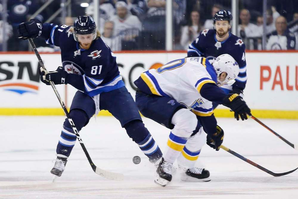 John Woods / The Canadian Press files
Jets forward Kyle Connor (left, skating past Blues forward Oskar Sundqvist) will be swinging for low scores at the Players Cup golf tournament in Winnipeg in August.