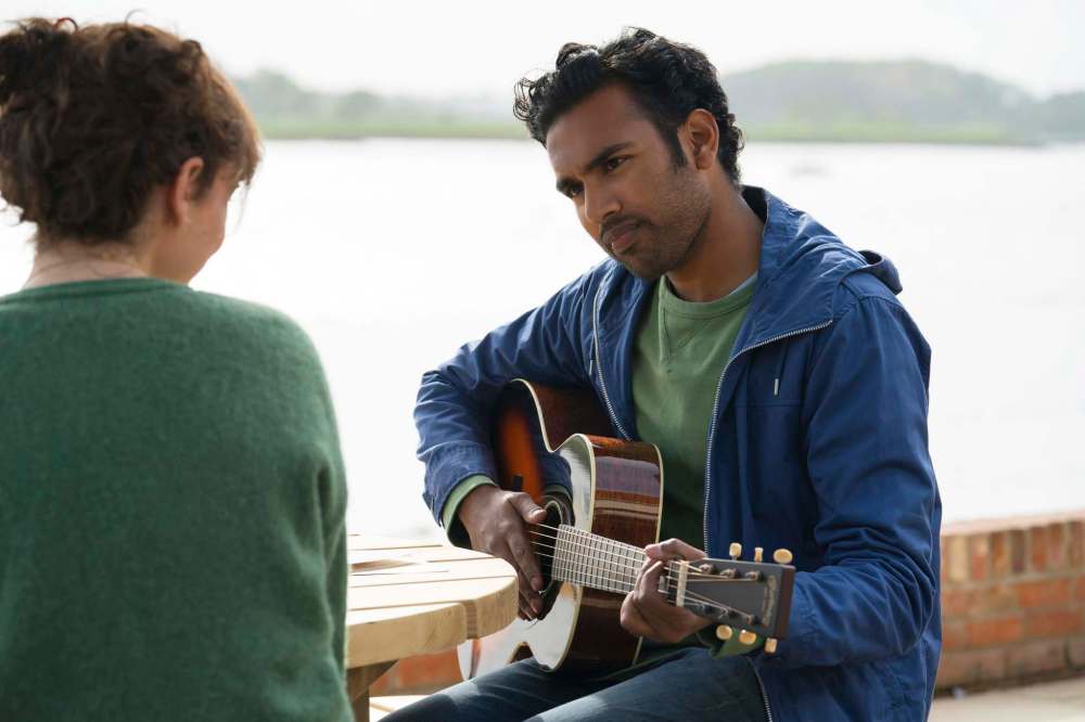 This image released by Universal Pictures shows Lily James,, left, and Himesh Patel in a scene from
