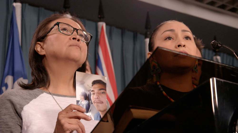 Debbie Baptiste, the mother of Colten Boushie, holds a photo of her son during a press conference on Parliament Hill in Ottawa last year.