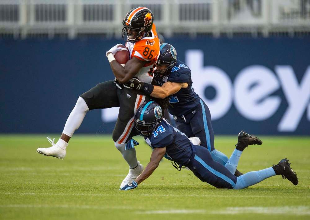 Andrew Lahodynskyj / The Canadian Press files
B.C. Lions receiver Jevon Cottoy (from left) is tackled by Argos defenders Ian Wild and Abdul Kanneh during CFL play this past Saturday in Toronto.