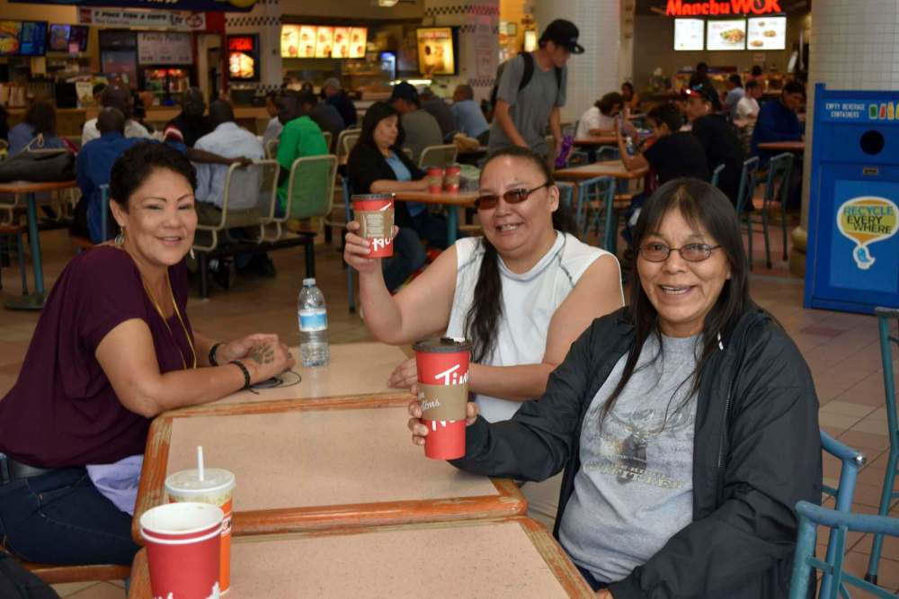 TESSA VANDERHART / WINNIPEG FREE PRESS
From left: Gail Walker, Tammy Owen and Adamina Fisher enjoy a coffee and conversation at Portage Place Wednesday afternoon. They say it's convenient to meet there and they hope the mall's potential sale doesn't change a thing.