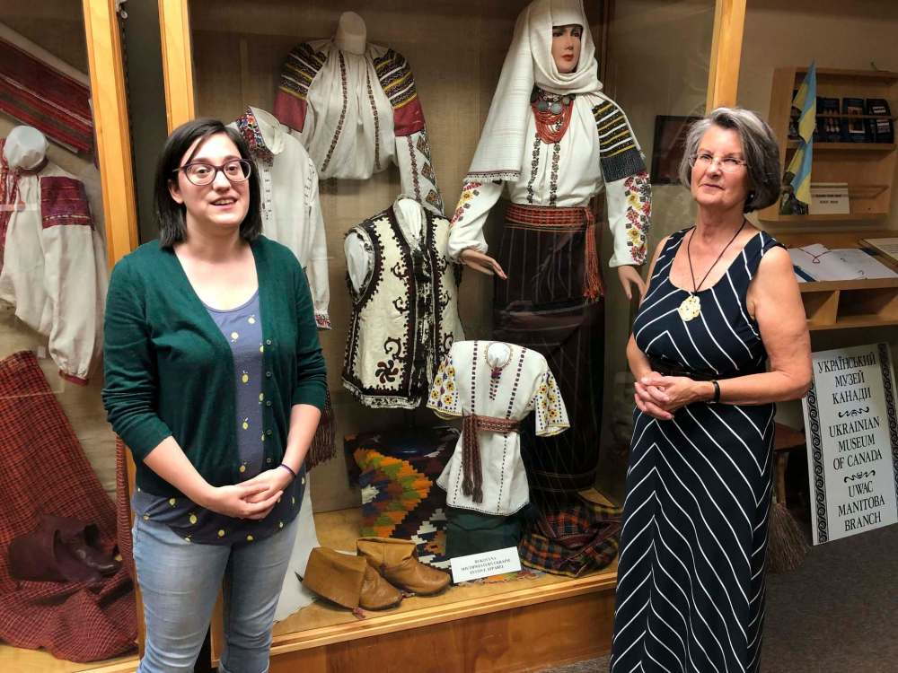 John Longhurst / Winnipeg Free Press 
Student Jillian Chomiak (left), and Marusia Foster, chairwoman of the Ukrainian Museum of Canada’s Manitoba branch, in front of a display of traditional embroidered Ukrainian clothing.