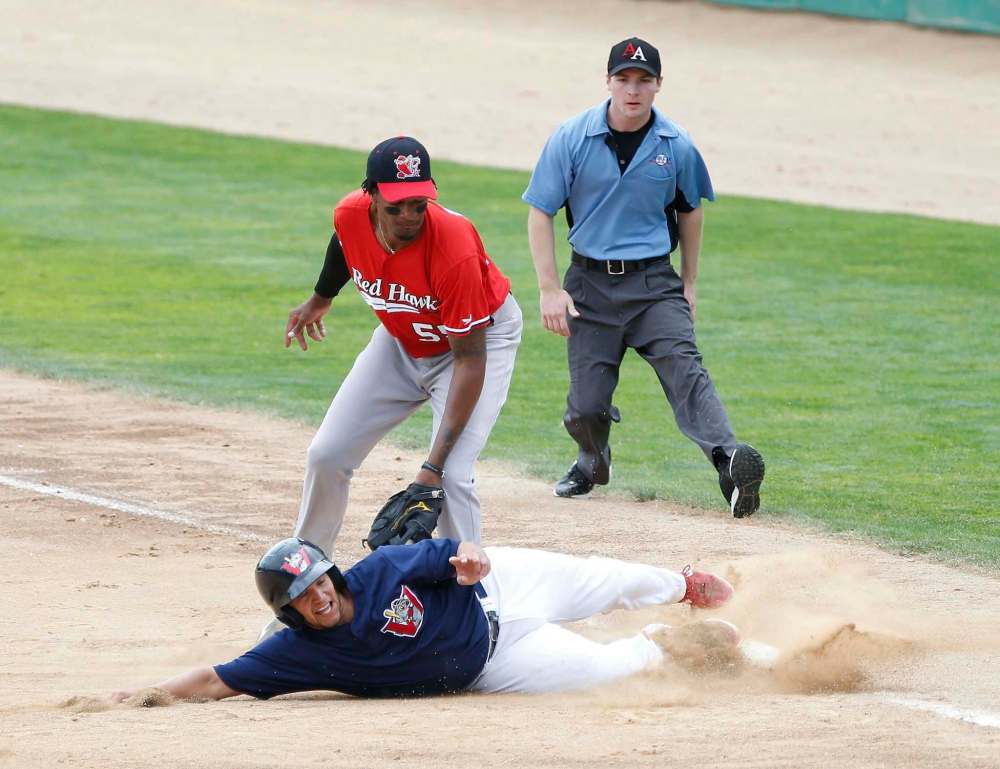 JOHN WOODS / WINNIPEG FREE PRESS
RedHawks’ Correlle Prime attempts to tag a Goldeye as he slides back to first.