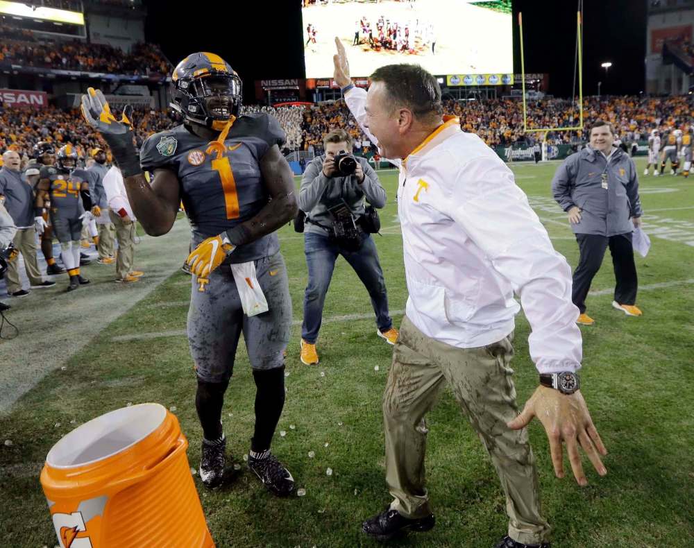 Mark Humphrey / The Associated Press files
Tennessee head coach Butch Jones reacts after defensive lineman Jonathan Kongbo gave him a Gatorade shower after a victory in 2016.