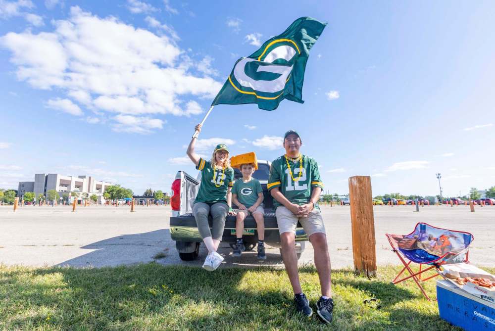 SASHA SEFTER / WINNIPEG FREE PRESS
Green Bay Packers die hard fans (from left) Randi, Burke (7) and Tommy Thomas have a parking lot to themselves to do some tailgating before the NFL pre-season game between the Green Bay Packers and Oakland Raiders at IG Field Thursday evening.