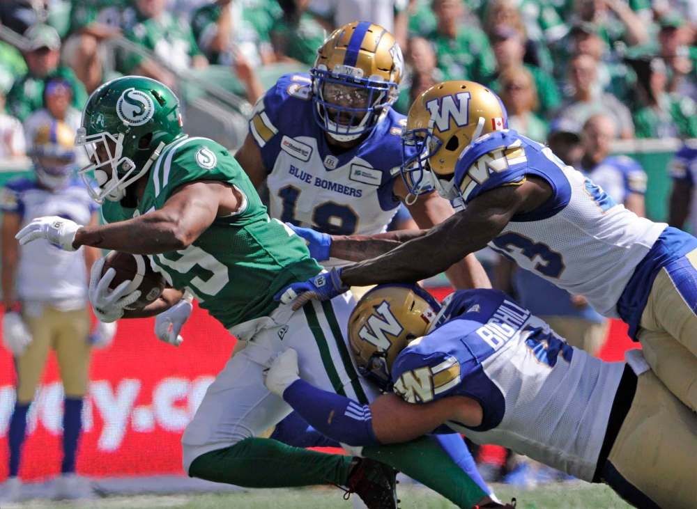 MARK TAYLOR / THE CANADIAN PRESS
Saskatchewan Roughriders running back William Powell fights for yards during first half CFL action against the Winnipeg Blue Bombers, in Regina on Sunday, Sept. 1, 2019.