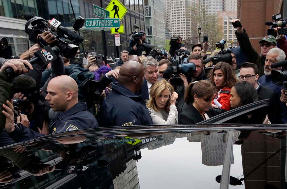 Steven Senne / the associated press files
Felicity Huffman climbs into a vehicle followed by her brother, Moore Huffman Jr., outside a federal court in Boston in May, when she pleaded guilty to charges in a U.S. college admissions bribery scandal.