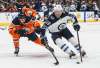 THE CANADIAN PRESS/Jason Franson
Winnipeg Jets' Jack Roslovic is chased by Edmonton Oilers' Matt Benning during first period NHL preseason action in Edmonton, Monday.