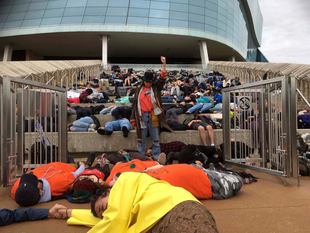 RUTH BONNEVILLE / WINNIPEG FREE PRESS
The Manitoba Youth for Climate Action holds Youth-Led Demonstration for Climate Action: Die-In at CMHR on Friday. Activist Victoria Redsun stands among the symbolically dead students in a mock demonstration symbolizing the strength of the indigenous people from the effects of climate change on the steps of the CMHR Friday.