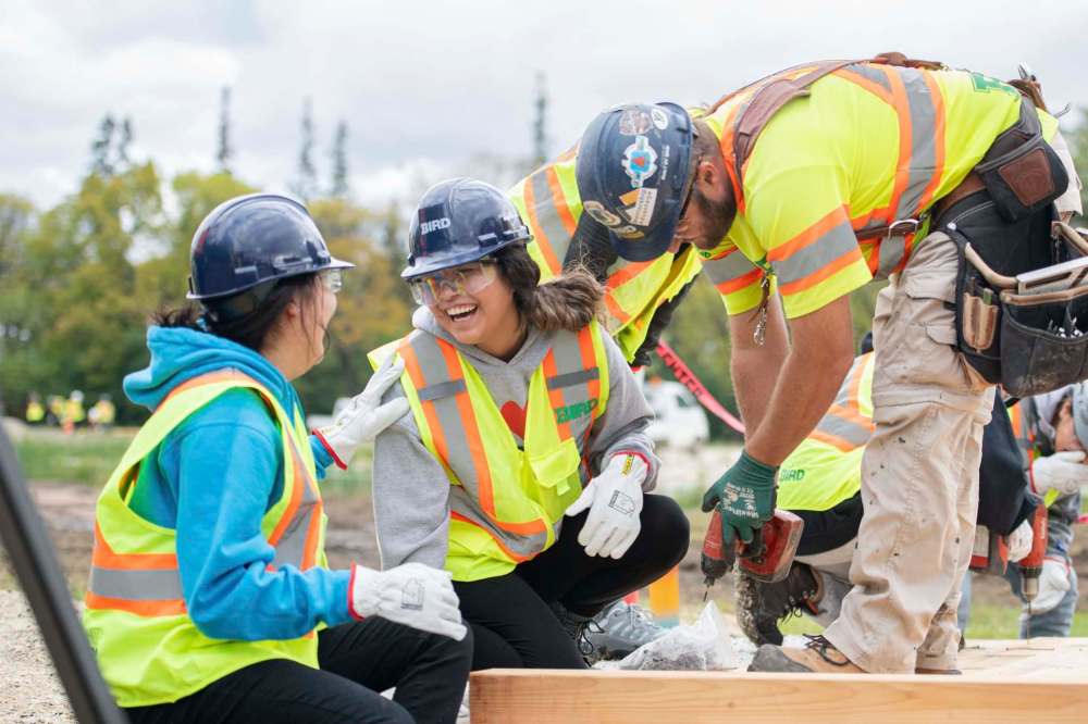 Mike Sudoma / Winnipeg Free Press
Geena North laughs as she learns some construction skills while she and other Indigenous youth build footbridges in the Indigenous Peoples’ Gardens in Assiniboine Park Wednesday.