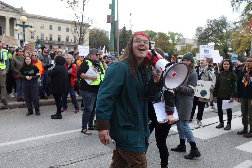 RUTH BONNEVILLE / WINNIPEG FREE PRESS
Lena Andres of Manitoba Youth for Climate Action rallies hundreds of students, teachers, parents and supporters at the start of the Climate Strike walk along Broadway on Friday.