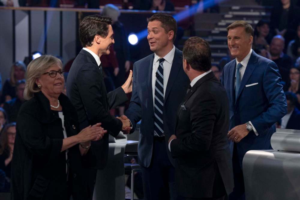 THE CANADIAN PRESS/Justin Tang
Liberal leader Justin Trudeau shakes hands with Conservative leader Andrew Scheer as People's Party of Canada leader Maxime Bernier, Bloc Quebecois leader Yves-Francois Blanchet and Green Party leader Elizabeth May leave the stage following the Federal leaders debate in Gatineau, Que. on Monday.