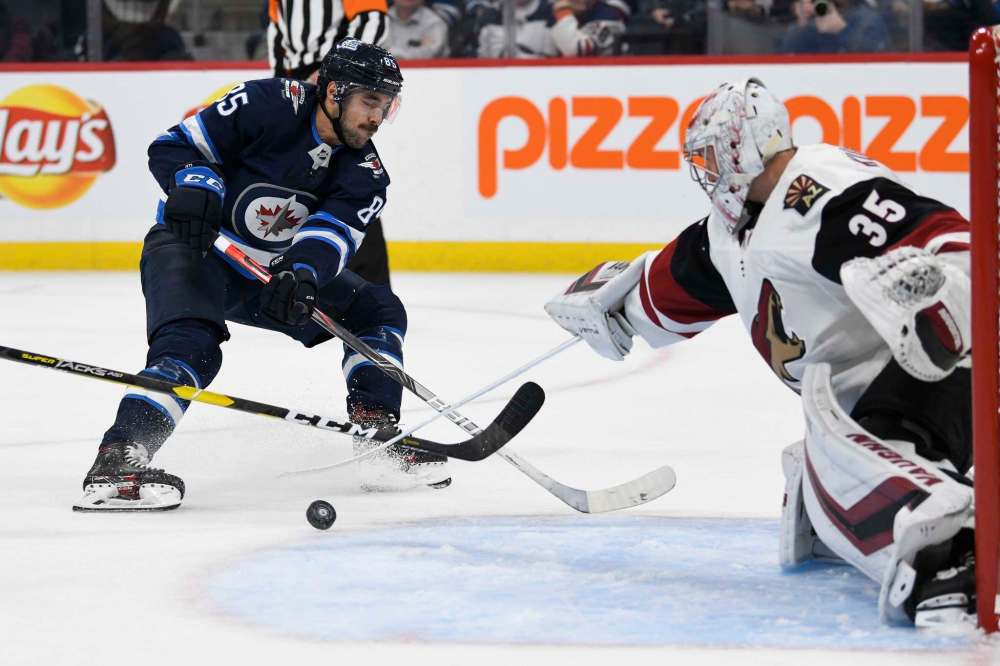 Coyotes goaltender Darcy Kuemper makes a save on Mathieu Perreault during the second period Tuesday. (Fred Greenslade / The Canadian Press)