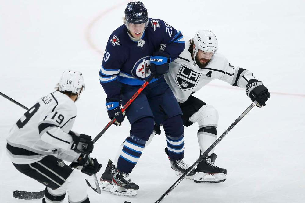 JOHN WOODS / WINNIPEG FREE PRESS
Kings defenceman Drew Doughty (right) and teammate Alex Iafallo tie up Jets forward Patrik Laine during Tuesday night’s game at Bell MTS Place. Doughty admits to holding grudges against certain players.