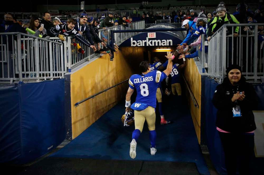 THE CANADIAN PRESS/John Woods
Winnipeg Blue Bombers quarterback Zach Collaros celebrates with fans after defeating the Calgary Stampeders in CFL action in Winnipeg Friday.