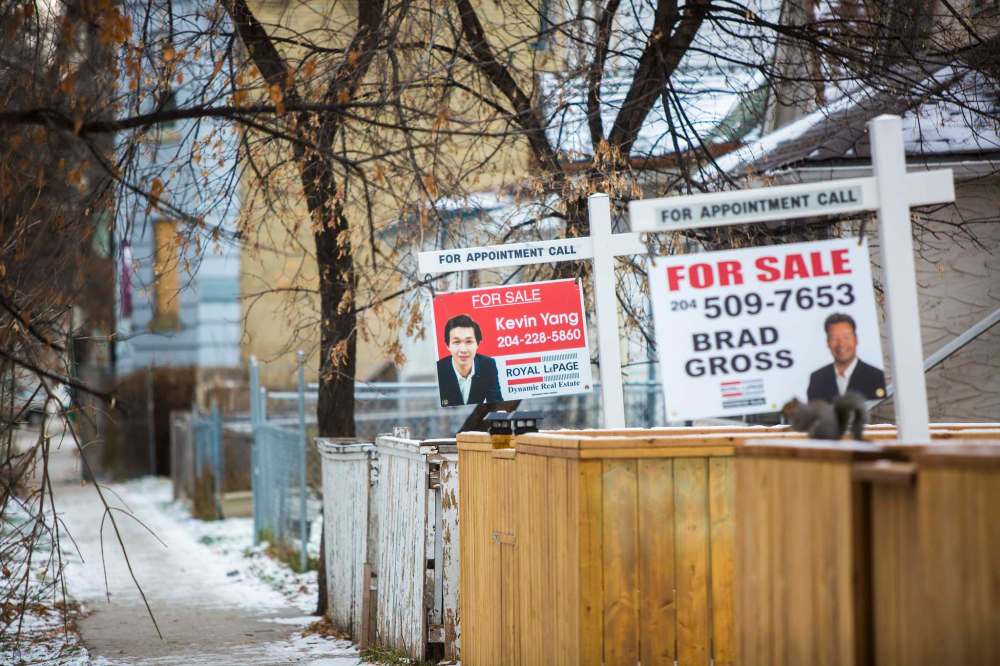 Mikaela MacKenzie/Winnipeg Free Press
Plenty of for-sale signs, such as these in the West End, are scattered throughout the city. Homebuyers have plenty of houses to choose from and the average price of a detached home has decreased from last October.