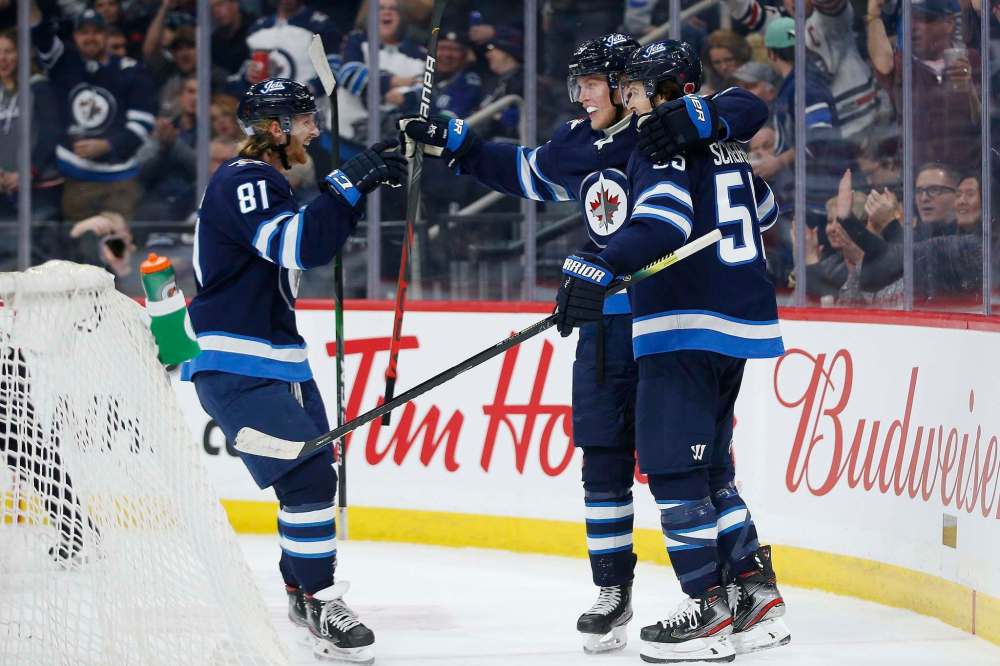 THE CANADIAN PRESS/John Woods
Winnipeg Jets' Mark Scheifele, right, celebrates his goal with teammates Kyle Connor, left and Patrik Laine during the second period against the Vancouver Canucks, Friday.