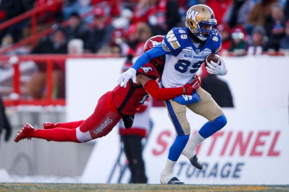 JEFF MCINTOSH / THE CANADIAN PRESS
Winnipeg Blue Bombers' Kenny Lawler, right, is grabbed by Calgary Stampeders' Royce Metchie.