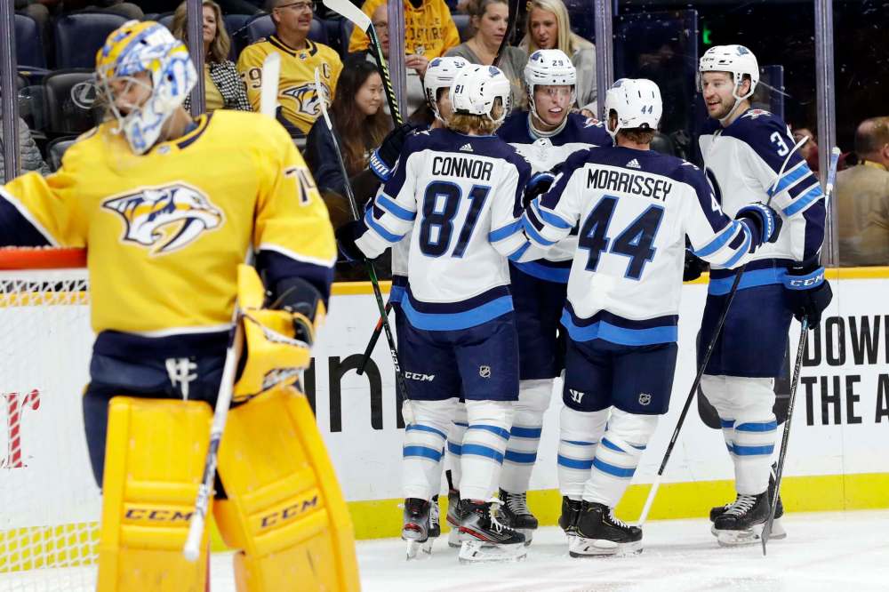 (AP Photo/Mark Humphrey)
Winnipeg Jets right wing Patrik Laine celebrates with teammates after scoring on Nashville Predators goaltender Juuse Saros early in the first period Tuesday in Nashville.