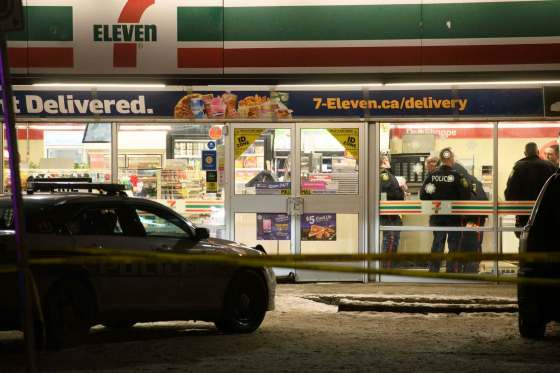 Mike Sudoma / Winnipeg Free PressPolice officers inside of the 7-Eleven on the corner of Arlington St. and Ellice Ave. after it became the scene of an officer-involved shooting Thursday evening.