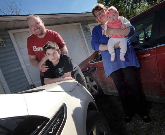 PHIL HOSSACK / WINNIPEG FREE PRESSTyson Beasley and April Fields, with their son, Andrew, and daughter, Abigail, will charge their Volt electric cars using power from the solar-energy system on their garage.