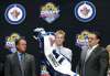 Alan Diaz / The Associated Press
Left-winger Kyle Connor pulls on a Winnipeg Jets sweater after being chosen 17th overall in the 2015 NHL Draft.