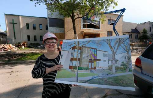 WAYNE GLOWACKI / WINNIPEG FREE PRESS
Rev. Carol Fletcher, a minister at Transcona Memorial United Church, shows off an artist's rendering of what the church building will look like once $1.75 million of renovations are completed. The upgrades will impove accessibility for wheelchair users and add a multi-purpose room and new washrooms.